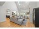 Open-concept living room with vaulted ceilings, skylights, and hardwood flooring at 7529 Tynewind Dr, Wake Forest, NC 27587