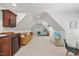 Living area with a bed, sofa, bar, and TV in an open floor plan, beneath angled ceilings at 7529 Tynewind Dr, Wake Forest, NC 27587