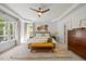 Calm, serene main bedroom with a tray ceiling, decorative rug, and ample natural light at 7529 Tynewind Dr, Wake Forest, NC 27587