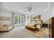 Relaxing primary bedroom with tray ceiling, ceiling fan, sitting area and natural light at 7529 Tynewind Dr, Wake Forest, NC 27587