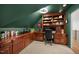 Cozy office with green walls, custom built-in desk with shelving, and carpeted floors at 7529 Tynewind Dr, Wake Forest, NC 27587