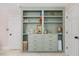 Built in shelving and storage painted green with bronze hardware at 7529 Tynewind Dr, Wake Forest, NC 27587