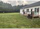 Expansive green backyard with trees and a view of the wooden deck at 8 Open View Ln, Timberlake, NC 27583