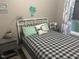 Comfortable bedroom with white metal frame bed and coastal-themed decor at 8 Open View Ln, Timberlake, NC 27583