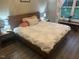 Cozy bedroom featuring a wooden bed frame, accent pillows, and natural light at 8 Open View Ln, Timberlake, NC 27583