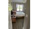 Bedroom featuring a wooden bed frame, white comforter, hardwood floors and a decorative window at 8 Open View Ln, Timberlake, NC 27583