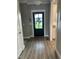 Entryway showcasing luxury vinyl plank flooring and a stylish front door at 8 Open View Ln, Timberlake, NC 27583