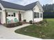 Charming single-story home with cozy front porch, outdoor seating, and well-manicured lawn at 8 Open View Ln, Timberlake, NC 27583