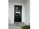 A black front door with a glass pane and a 'Home Sweet Home' welcome mat at 8 Open View Ln, Timberlake, NC 27583