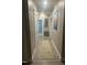 Bright hallway with neutral walls, hardwood floors, and multiple doors, creating a seamless flow throughout the home at 8 Open View Ln, Timberlake, NC 27583
