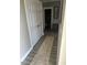Hallway with wood floors, neutral walls, and closet space, leading to the bathroom providing practicality and style at 8 Open View Ln, Timberlake, NC 27583