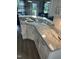 Kitchen island with white cabinets and granite countertops overlooks the backyard at 8 Open View Ln, Timberlake, NC 27583