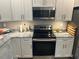 Kitchen featuring stainless steel appliances, granite countertops, and white cabinets at 8 Open View Ln, Timberlake, NC 27583