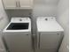 Modern laundry room with side-by-side Samsung washer and dryer units at 8 Open View Ln, Timberlake, NC 27583