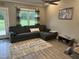 Living room featuring a comfortable gray sectional sofa and modern decor at 8 Open View Ln, Timberlake, NC 27583