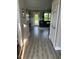 Entryway view of the living room featuring a black sofa and outdoor views at 8 Open View Ln, Timberlake, NC 27583