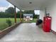 A covered patio with vintage refrigerator, open view of the backyard and wooden supports at 8 Open View Ln, Timberlake, NC 27583
