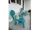 Inviting porch with Adirondack chairs, side table and colorful tropical cushions on a covered porch at 8 Open View Ln, Timberlake, NC 27583