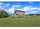 Two story home with a backyard that features a well-maintained lawn, and small wooden deck at 86 Woodall Farm Ln, Princeton, NC 27569
