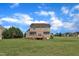 Two story home with a backyard that features a well-maintained lawn, and small wooden deck at 86 Woodall Farm Ln, Princeton, NC 27569