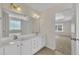 Bathroom with double sinks, white cabinetry, a large mirror and access to the bedroom at 86 Woodall Farm Ln, Princeton, NC 27569