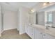 Bathroom featuring double sinks, white cabinets, and a large mirror with decorative lighting at 86 Woodall Farm Ln, Princeton, NC 27569