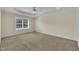 Spacious bedroom with neutral carpet, tray ceiling, and a window providing natural light at 86 Woodall Farm Ln, Princeton, NC 27569