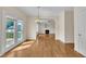 Open dining area with hardwood floors and access to a deck and living room with fireplace at 86 Woodall Farm Ln, Princeton, NC 27569