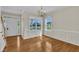 Bright dining room featuring hardwood floors, wainscoting, and large windows providing natural light at 86 Woodall Farm Ln, Princeton, NC 27569