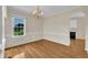Elegant dining room with hardwood floors, chair rail molding, and a chandelier over a large window at 86 Woodall Farm Ln, Princeton, NC 27569