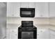 Bright kitchen with white cabinets, modern black appliances, and a functional layout for cooking at 86 Woodall Farm Ln, Princeton, NC 27569