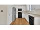 Functional kitchen with white cabinets, stainless steel refrigerator, and black appliances at 86 Woodall Farm Ln, Princeton, NC 27569