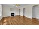 Bright living room featuring hardwood floors, a fireplace and arched doorways with built-in shelving at 86 Woodall Farm Ln, Princeton, NC 27569