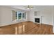 Sun-filled living room with large windows, hardwood floors, and a fireplace with a white mantel at 86 Woodall Farm Ln, Princeton, NC 27569