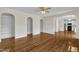 Open-concept living room boasts hardwood floors, archways with built-in shelving, and a view to the kitchen at 86 Woodall Farm Ln, Princeton, NC 27569