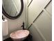 Elegant powder room featuring a marble vessel sink, dark faucet, and custom wall trim at 917 Widewaters Pkwy, Knightdale, NC 27545