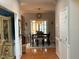 Well-lit dining area with hardwood floors, a large window, and a modern chandelier at 917 Widewaters Pkwy, Knightdale, NC 27545