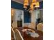 Elegant dining room with a wood table, seating for six, and a beautiful, decorative chandelier at 917 Widewaters Pkwy, Knightdale, NC 27545