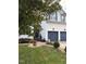 Home featuring a two-car garage, a manicured lawn with garden beds, and mature trees at 917 Widewaters Pkwy, Knightdale, NC 27545