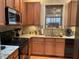 This cozy kitchen features granite counters, wood cabinets, and stainless steel appliances at 917 Widewaters Pkwy, Knightdale, NC 27545