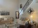 Cozy living room with vaulted ceiling, sofas, and a large painting at 917 Widewaters Pkwy, Knightdale, NC 27545