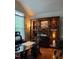 Inviting home office with a glass desk and built-in shelving, offering a functional and stylish workspace at 917 Widewaters Pkwy, Knightdale, NC 27545