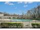 Community pool area with trees in the background, and a playground off to the side at 917 Widewaters Pkwy, Knightdale, NC 27545