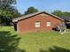 A sunny backyard features a well-kept lawn and an adorable playhouse, perfect for outdoor fun and relaxation at 1021 Delray St, Durham, NC 27713