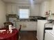 Functional kitchen has a stainless steel sink, a white electric range and ample counter space at 1021 Delray St, Durham, NC 27713