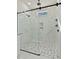 Elegant glass shower with stone tile flooring, marble walls, and a rain shower head at 110 Mohave Dr, Louisburg, NC 27549