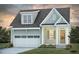 Charming two-story home featuring a front-entry garage, covered porch, and beautifully landscaped yard at 1205 Barreto Dr, Wendell, NC 27591