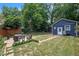 Inviting backyard retreat with cozy patio seating, lush green lawn, and charming shed at 1213 Pierce St, Raleigh, NC 27605