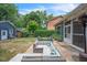 Landscaped backyard featuring a patio, outdoor furniture, a shed, and lush greenery at 1213 Pierce St, Raleigh, NC 27605
