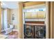 Laundry area with washer/dryer, built-in cabinets, shelving and connected toilet area at 1213 Pierce St, Raleigh, NC 27605